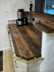 Custom brass kitchen rail for bar counter with hooks for utensil storage