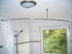 Barrier-free round curtain shower rod for accessible bathroom, floor-level shower in quarter-circle shape, sturdy in stainless steel