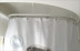 Disabled-accessible round curved shower curtain rod in white,closed